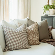 Madeleine taupe botanical pillow styled in a living room