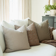 Odette terracotta botanical pillow in a living room