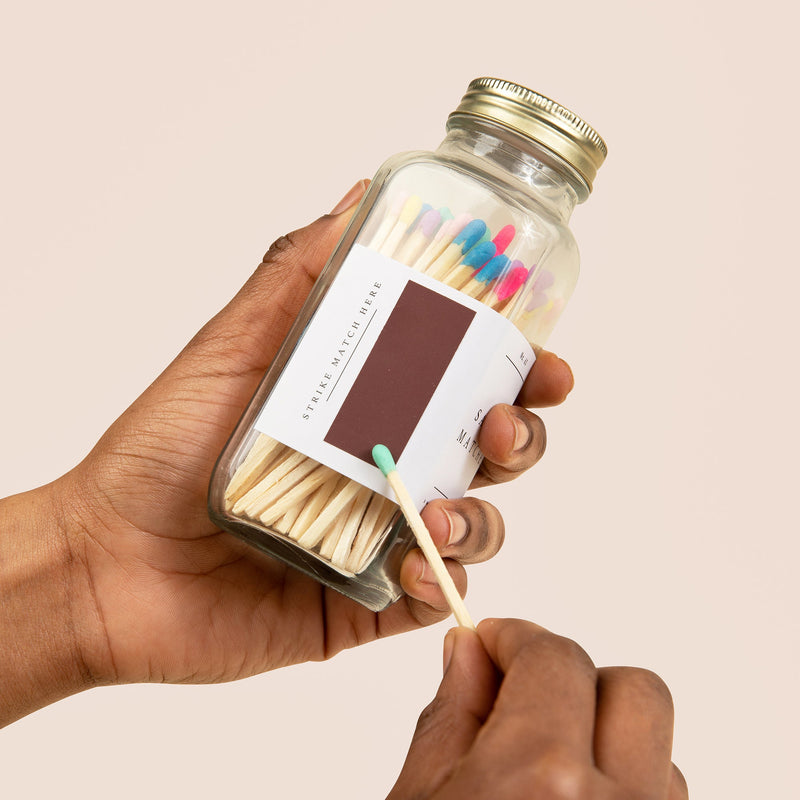 Sweet Water Decor rainbow matches styled beside candle