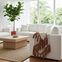 Kora terracotta stitch cotton throw styled in a living room