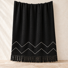 Black chevron cotton throw with white hand-stitched zigzag pattern