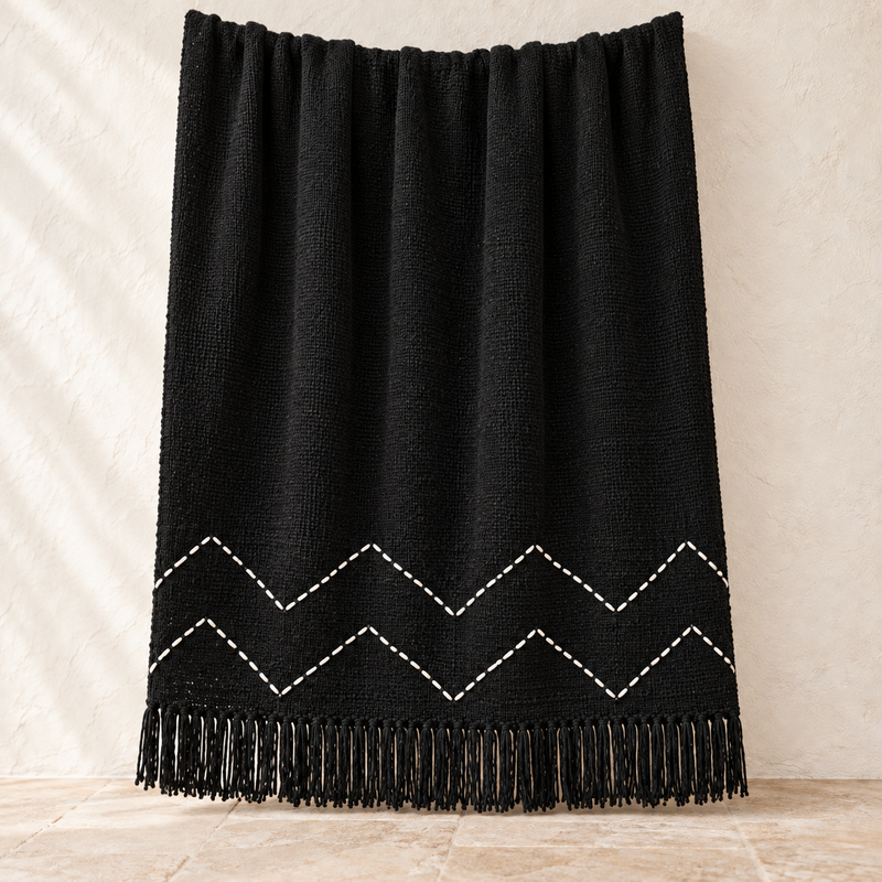 Black chevron cotton throw with white hand-stitched zigzag pattern