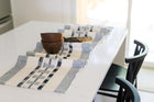 Artisanal hand-spun cotton table runner with rep weaving detail