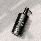 Modern black soap dispenser with embossed “Hand Soap” text