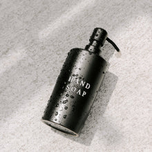 Modern black soap dispenser with embossed “Hand Soap” text