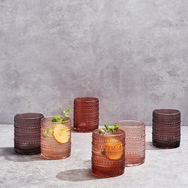 Lowball glasses styled with cocktails and citrus garnish