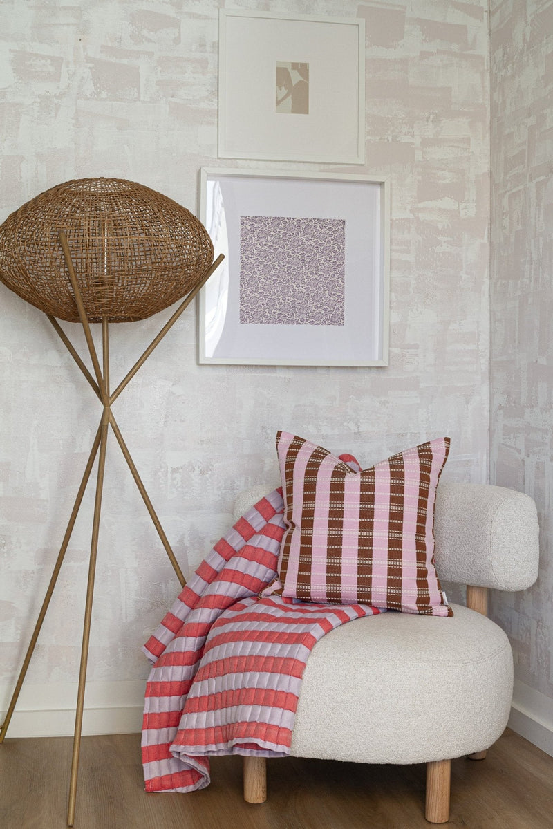 Quilted Sujani throw blanket in soft lilac and red styled in a home interior
