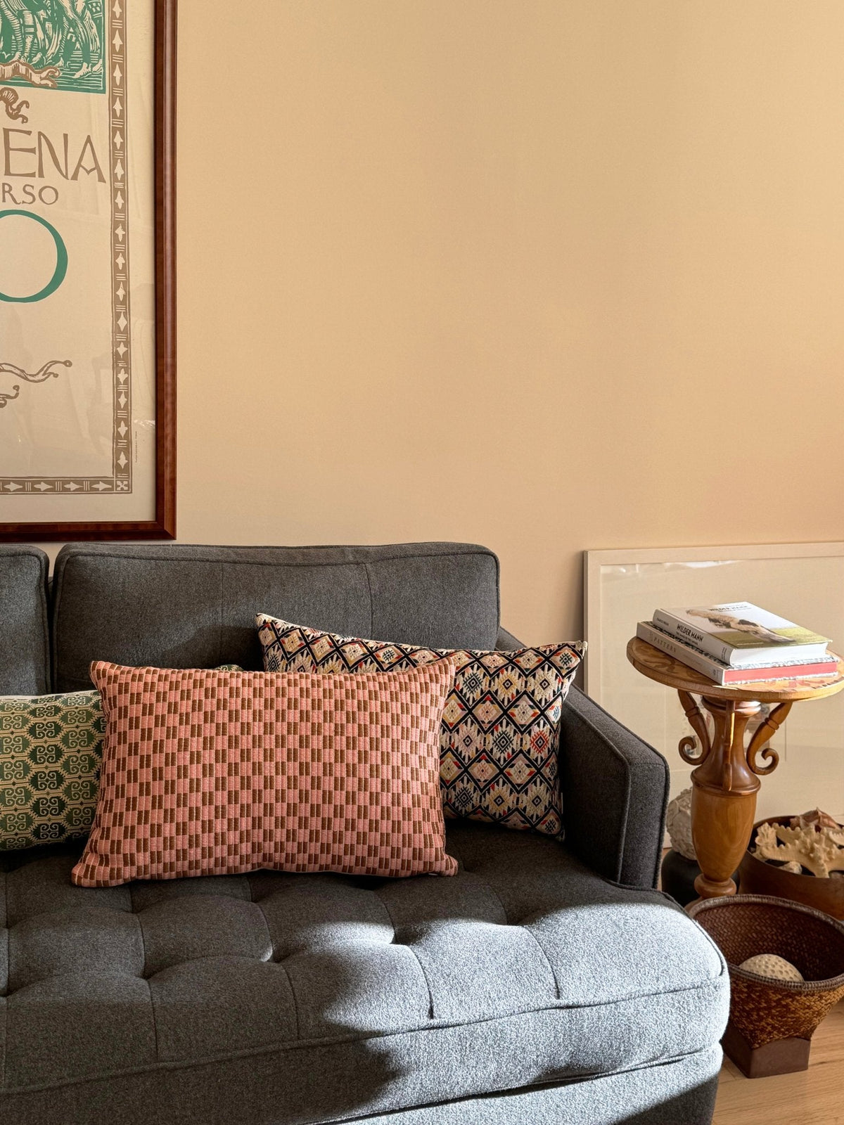Checkered brocade pillow in pink and umber styled in a home interior