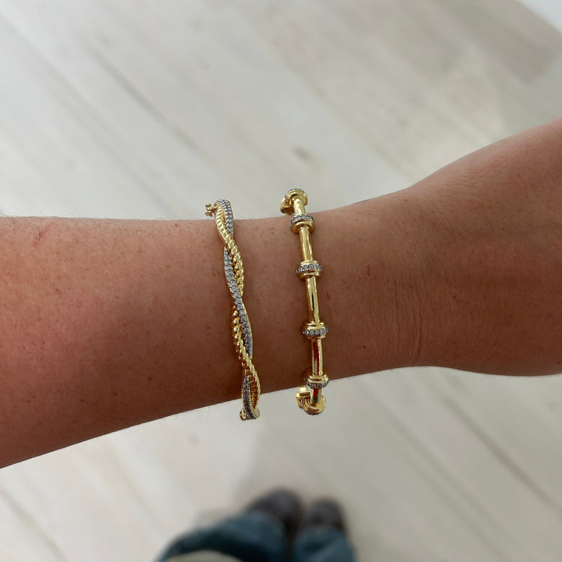 Close-up of twisted gold and silver bangle with pave detail