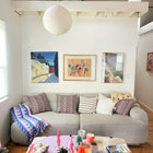 Palm ikat blanket in blue and pink styled in a home interior