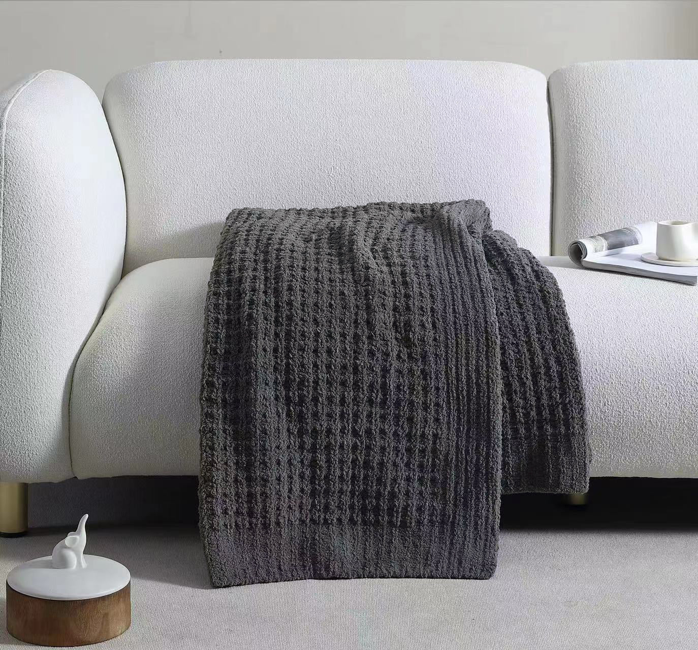 Soft waffle weave throw draped over sofa arm