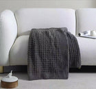 Soft waffle weave throw draped over sofa arm