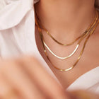 Triple-layer gold chain necklace styled on model