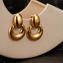 Elegant gold statement earring styled on model