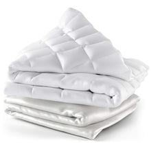 Weighted blanket with bamboo cover draped on bed