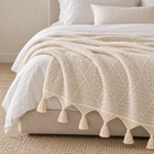 Cream organic cotton throw layered on a bed