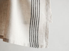 Artisan-made linen napkins in ivory and black stripes