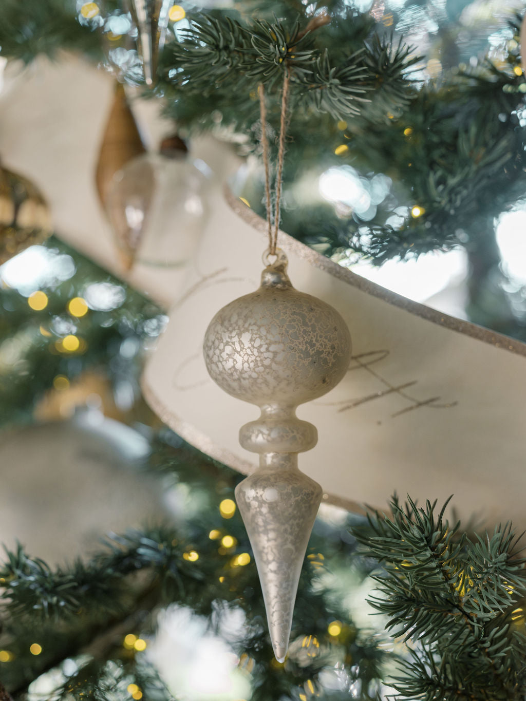 Neutral finial ornaments in matte, shiny, and clear finishes