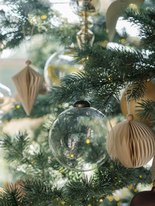 Elegant clear glass ornaments sparkling on holiday tree