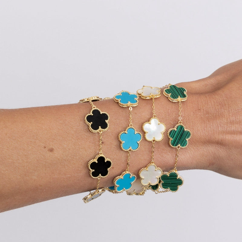 Dainty gold clover bracelet on wrist