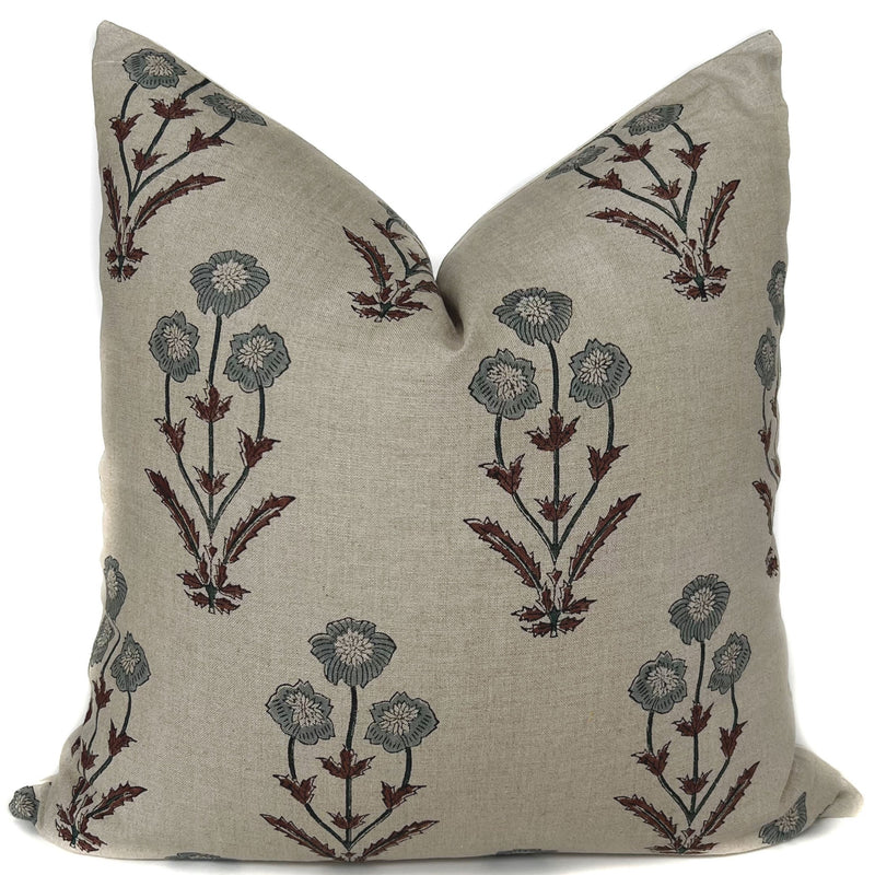 'Palo' Floral Throw Pillow by One Affirmation features a blue/grey flower with marron colored stems on a beige background. 