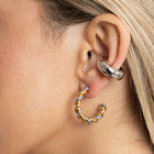 Close-up of two-tone twisted hoop earring