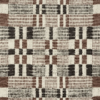 Brimfield Woven Pillow Cover in Cinder shown on a sofa