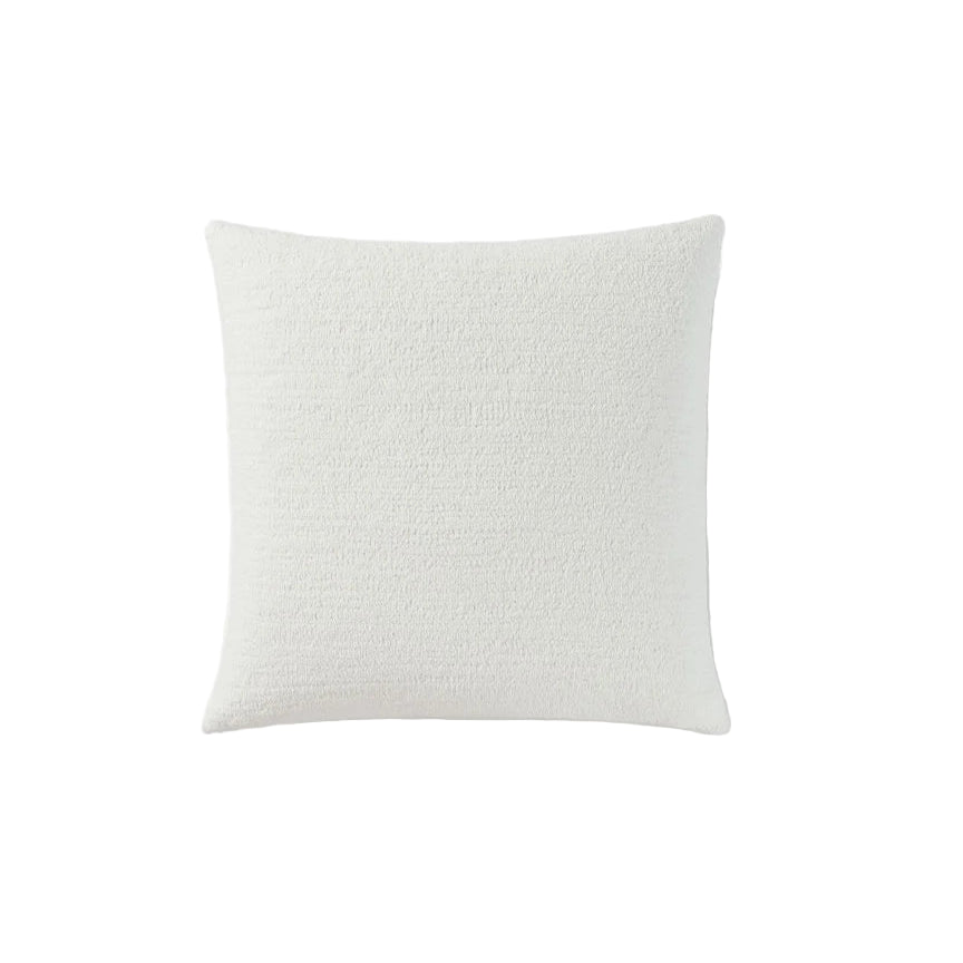 Snug Euro Sham styled on bed with layered pillows