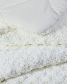 Close-up of waffle texture on plush Snug comforter