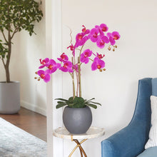Lifelike Artificial orchid plant with soft pink blooms