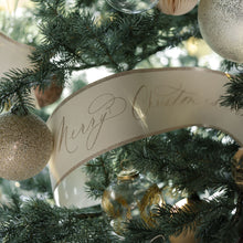 Christmas tree decorated with glittering Merry Christmas garland