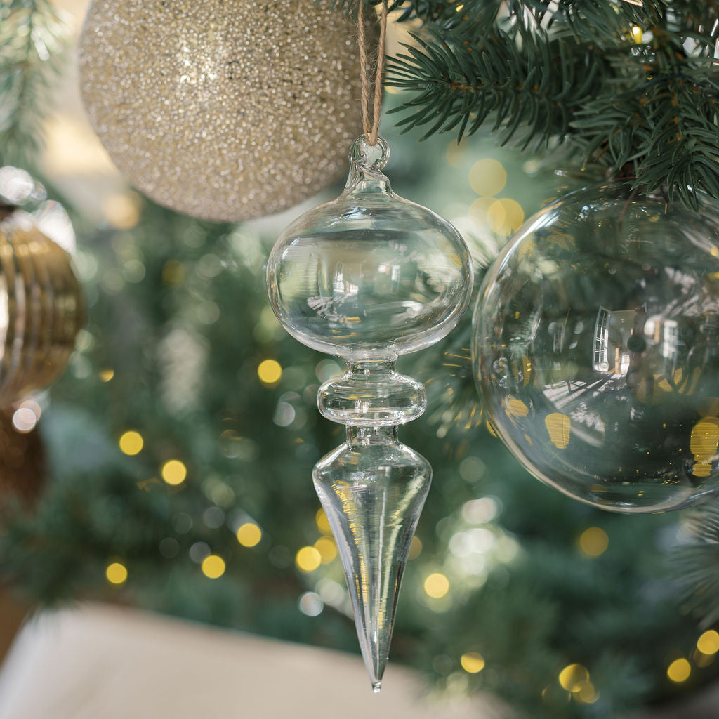 Classic clear glass ornaments reflecting light on Christmas tree