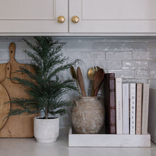 Faux greenery cedar tree in decorative pot