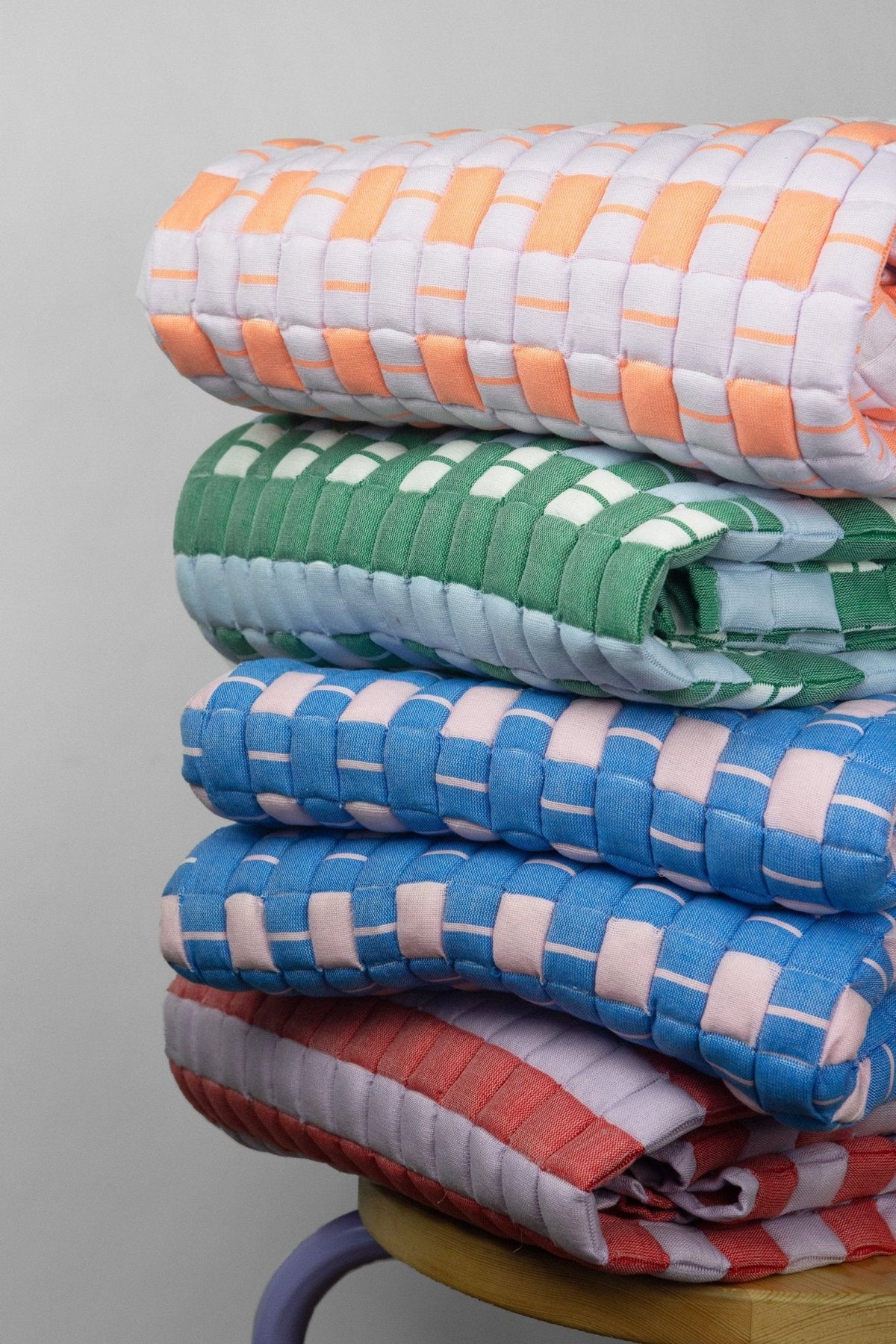 Close-up of a stack of handwoven quilted Sujani blankets