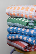 Close-up of a stack of handwoven quilted Sujani blankets