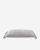 Elongated lumbar pillow in cozy braided design on sofa