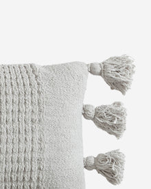 Close-up of braided Snug fabric and pom pom details