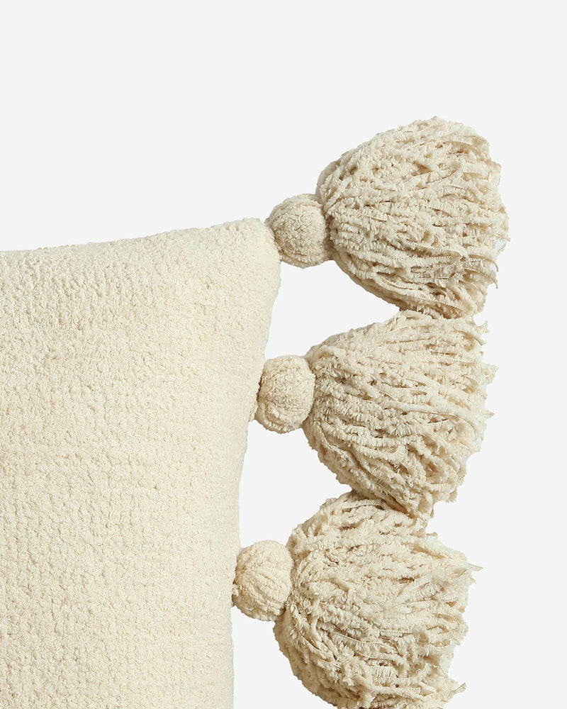 Decorative pillow with pom pom edge accents