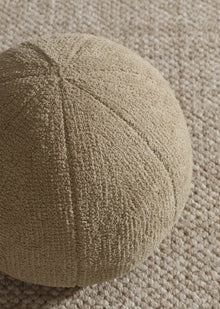 Plush sphere accent pillow on modern sofa