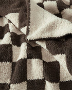 Country-chic checkerboard blanket folded at foot of bed