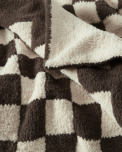 Country-chic checkerboard blanket folded at foot of bed