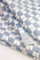Close-up of the quilted Sujani throw blanket weave in soft blue grey
