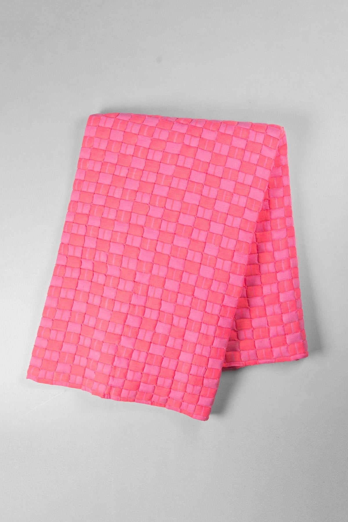 Quilted Sujani throw blanket in neon pink with stripe binding