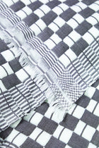 Close-up of the quilted Sujani throw blanket weave in soft black and white