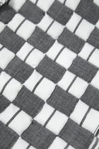 Close-up of the quilted Sujani throw blanket weave in soft black and white