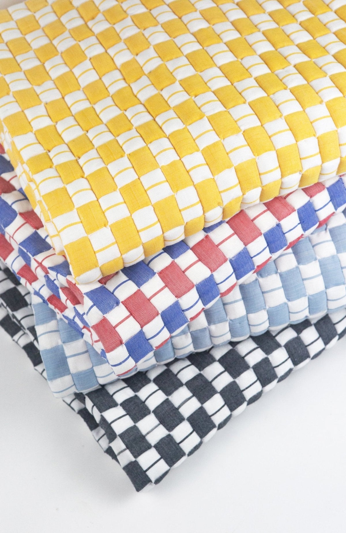 Quilted Sujani throw blanket in soft black and white, styled