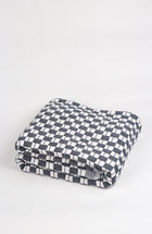 Quilted Sujani throw blanket in soft black and white, styled