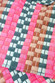 Close-up of the quilted Sujani throw blanket weave in multi green and pink