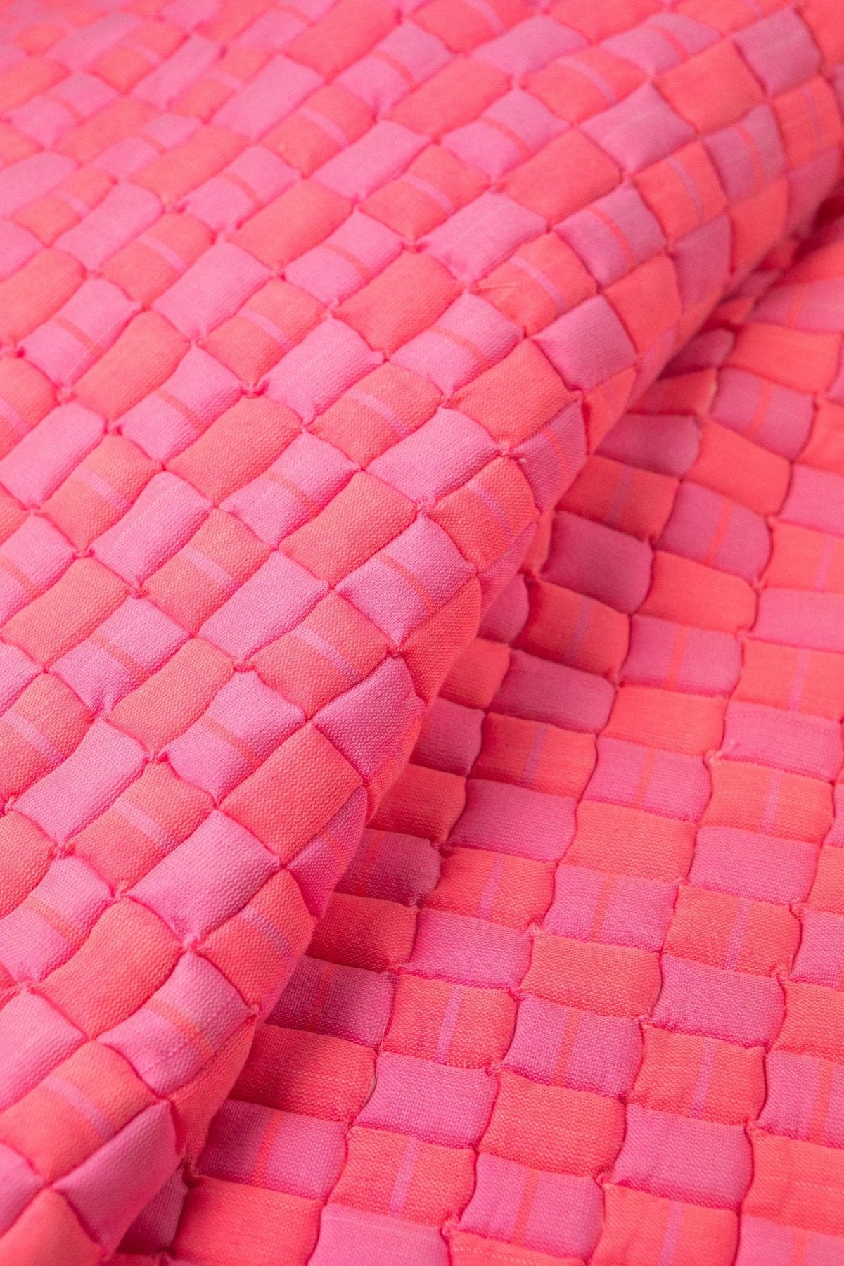 Close-up of the quilted Sujani throw blanket weave in neon pink