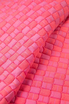 Close-up of the quilted Sujani throw blanket weave in neon pink